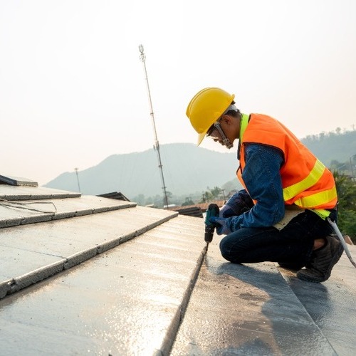worker providing standing seam metal roof installation