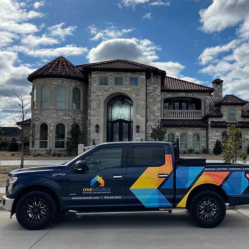 roofing contractor's truck in front of a brick house